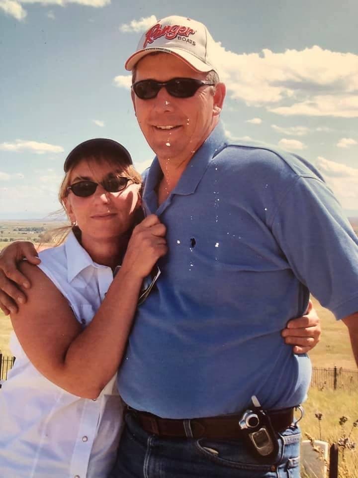 Rich and Susan Blank standing together on a hilltop under a big sky